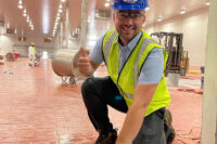 Scott Jr. laying the final Brick at Main Plant
